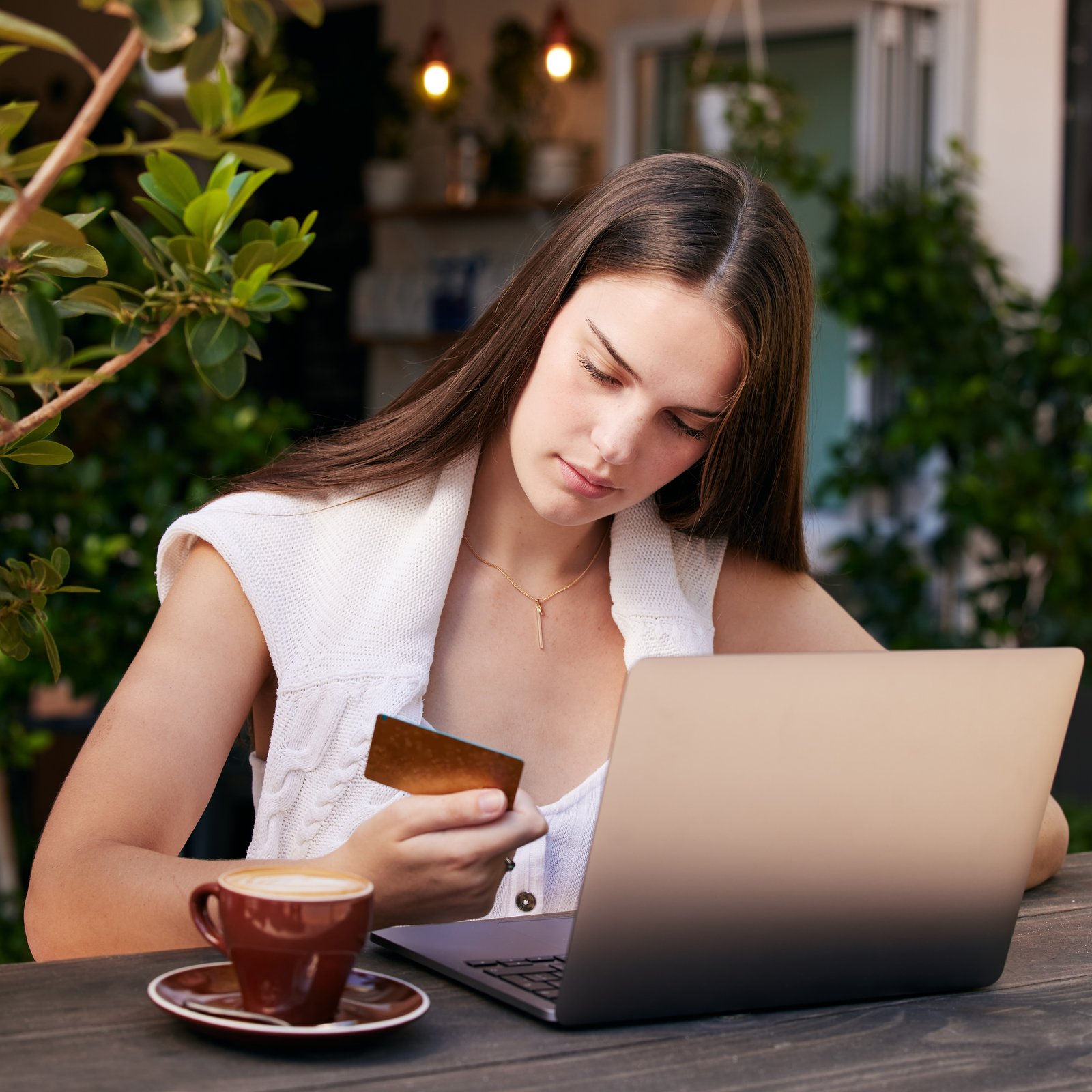 A person reading recession headlines while holding groceries
